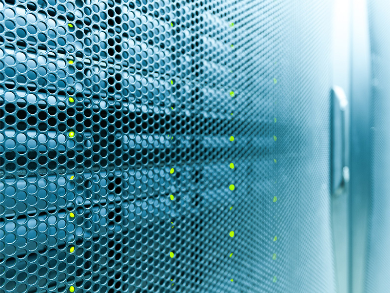 A server room with glowing green lights and an overlay of Joomla! and WordPress logos, signifying secure and efficient hosting solutions.